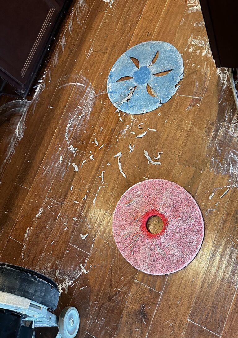 Buffing pads and residue lifted from a hardwood floor