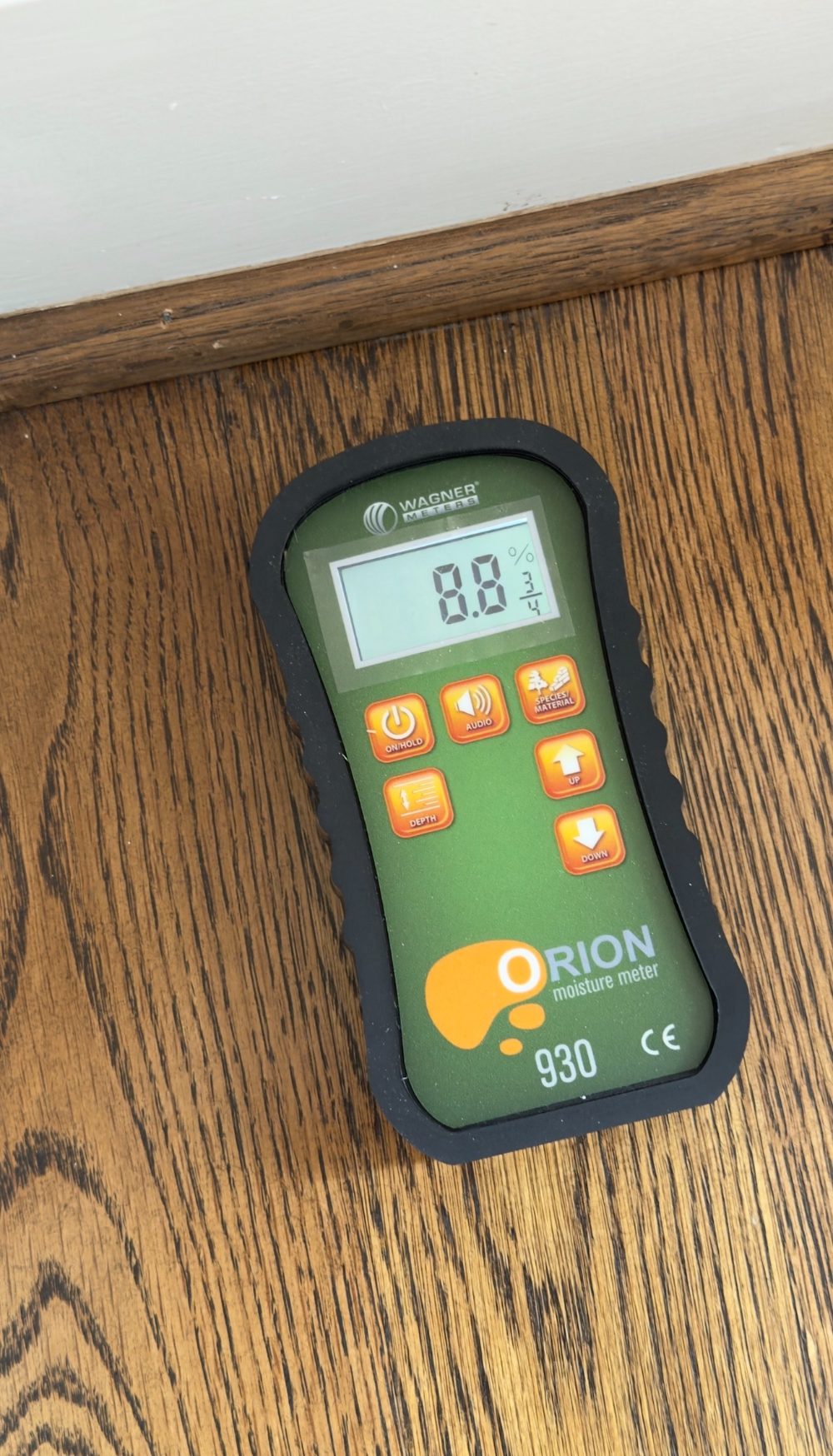 Moisture meter reading on a hardwood floor