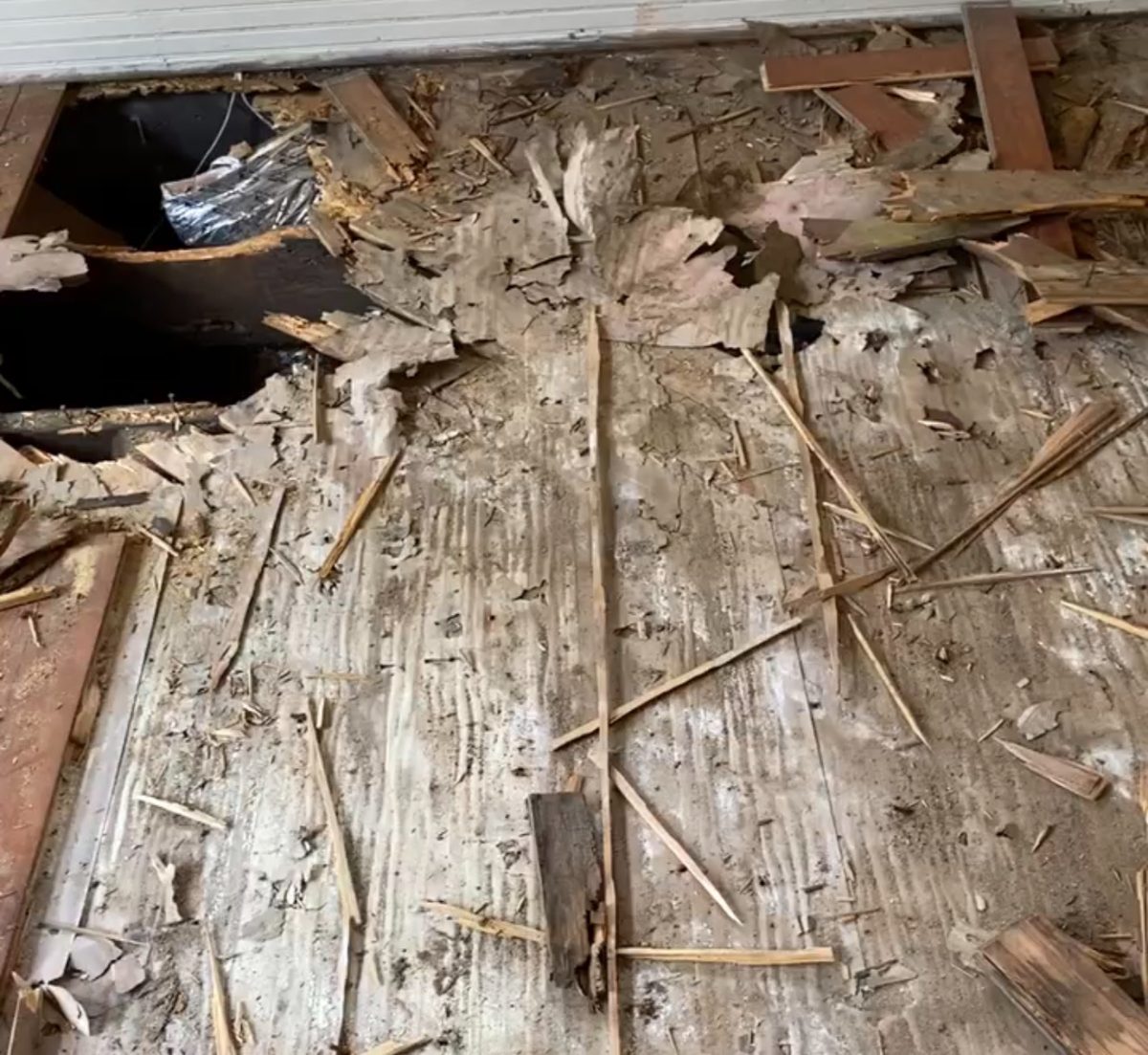Subfloor damage found under a hardwood floor during a repair